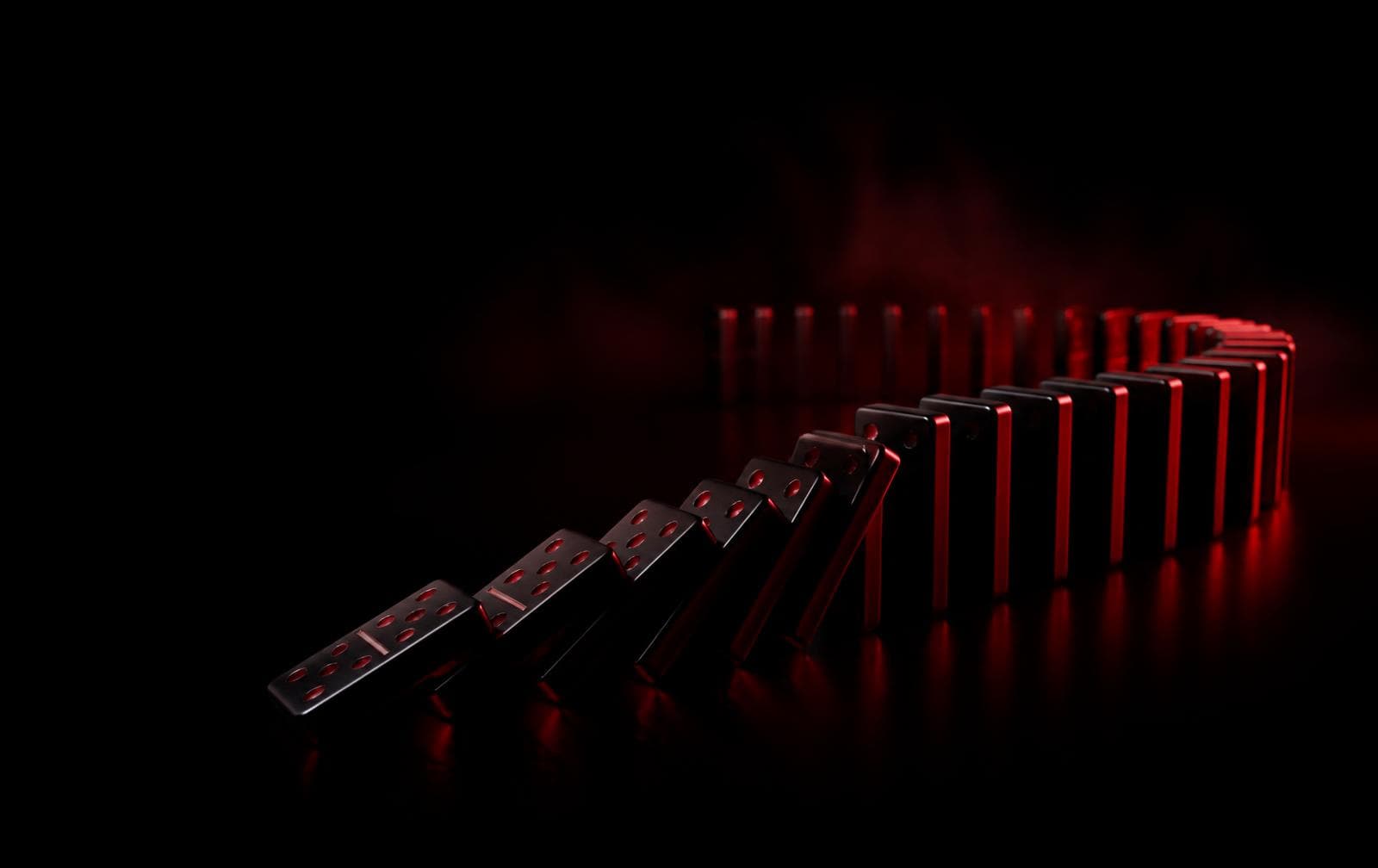 A curved chain of black dominoes toppling under red light